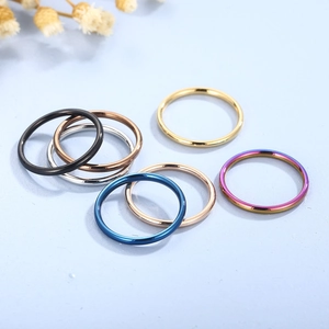 Minimalist 2mm stainless steel rings in multiple colors shown from a high-angle view