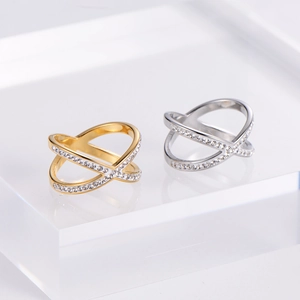 Close-up of gold and silver cross X rings with shimmering micro-pave zircon crystals