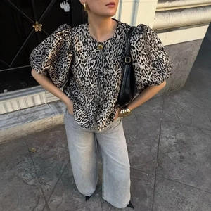 Elegant puff sleeve leopard print blouse styled with wide-leg trousers for a chic look