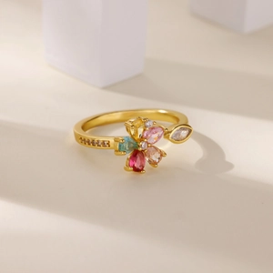 Luxurious gold flower ring with colorful zircon crystals on a geometric background