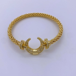 Elegant 18K gold plated braided bangle with moon-shaped clasp and pavé crystals