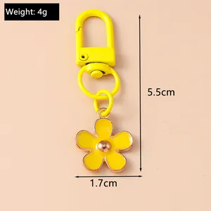 Detail showing dimensions of yellow flower keychain, 1.7cm width and 5.5cm total height