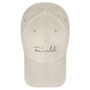 Classic beige cotton baseball cap with gold cursive embroidery on white background