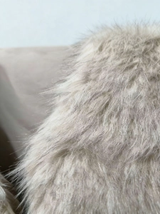 Close-up of fluffy light grey faux fur vest showing soft and premium plush texture