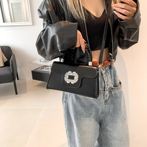 Minimalist black leather crossbody bag with a sparkling circular rhinestone buckle for women
