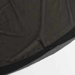 Detailed close-up of charcoal grey knit fabric texture with black ribbed hem stitching