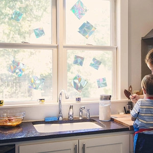 Rainbow prism static window film creating colorful laser light in a sunny kitchen scene