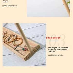 Detail of wooden jewelry display stand showing copper nail design and anti-slip base