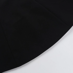 Detailed close-up of the black fabric texture and fine stitching on the slim dress