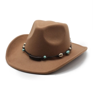Detail of camel wool felt cowboy hat featuring bohemian turquoise and shell beaded band