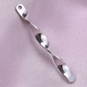 Close-up of twisted bar pendant in silver steel on elegant purple silk fabric