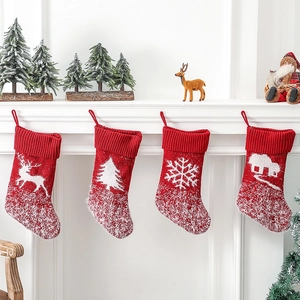 Set of 4 red knitted Christmas stockings with white reindeer and snowflake patterns
