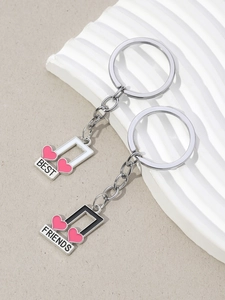 Detail of music note keychains with Best Friends engraving in black and white enamel