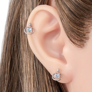 Silver Saturn cartilage stud with light blue zircon and star detail on model