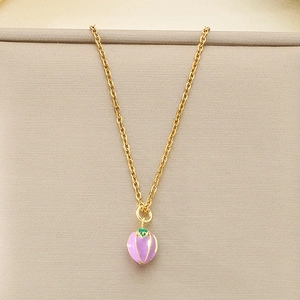 Macro view of purple mangosteen fruit pendant on a delicate gold titanium steel chain