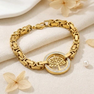 Macro detail of gold-plated tree of life bracelet with zircon pavé on beige texture