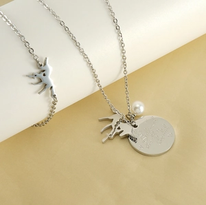 Detail of unicorn jewelry set with engraved inspirational quote and pearl accents