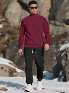 Detail of men's jacquard stand-collar sweater and joggers set with snowy mountain backdrop