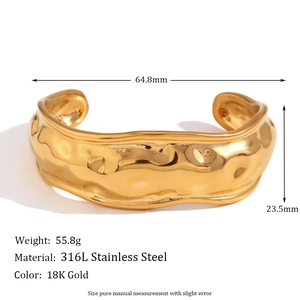 18K gold plated stainless steel wide bangle with irregular hammered texture on white background