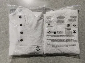Detail of white quilted knit sweatshirt with diamond texture and button collar in packaging