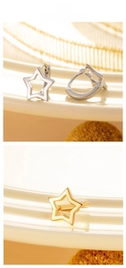 Detail display of hollow star hoop earrings in polished gold and silver finishes