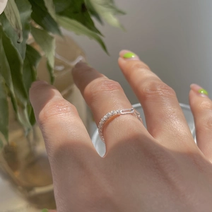 Detail of 925 silver plated ring with sparkling cubic zirconia and adjustable chain link