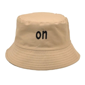 Detailed view of khaki cotton bucket hat with black embroidered on letter stitching