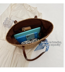 Spacious hand-woven straw tote bag showing interior lining and large capacity for daily items