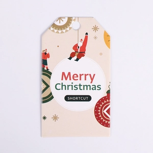 Close-up of beige Christmas tag with Santa Claus motif and Merry Christmas text