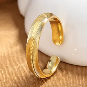Close-up of a gold-plated adjustable S925 silver ring with a wavy engraved pattern