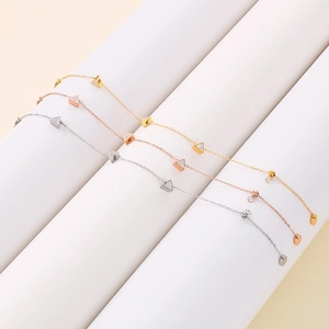 Detailed view of triangle diamond bracelets in gold, rose gold and silver finishes