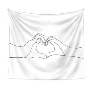 Detail of minimalist white tapestry featuring black line art hands forming a heart shape