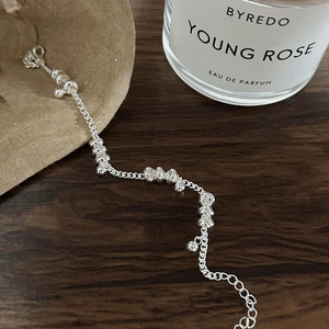 Detail of silver beaded chain bracelet with polished round rings and adjustable lobster clasp