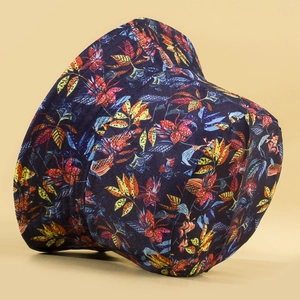 Navy blue reversible bucket hat featuring colorful tropical leaf patterns for summer sun protection
