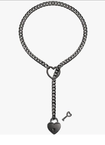 Detail of gothic black metal Cuban chain with heart-shaped padlock and decorative key