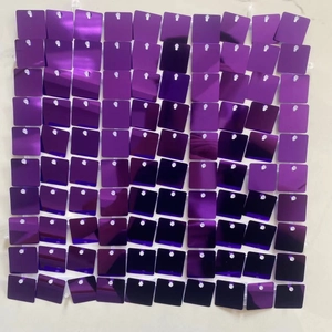 Close-up of square decorative shimmer wall panel with reflective purple sequins