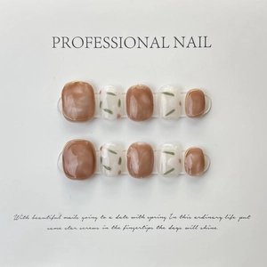 Handmade caramel marble and white press-on toenails with gold wire edging and herbal patterns