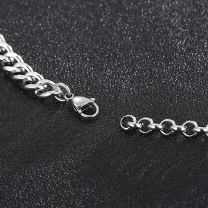 Macro shot of polished stainless steel Cuban chain showing lobster clasp detail and link