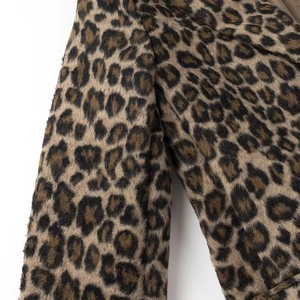 Detailed close-up showing the soft leopard print texture and plush fabric of the blazer