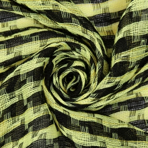 Macro shot of houndstooth desert scarf fabric rolled into a rose shape to show texture