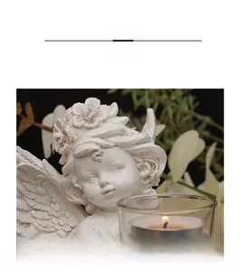 Macro shot of white angel figurine with floral headpiece and detailed wings holding candle