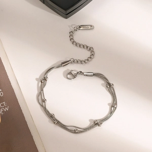 Detail of silver multi-layer stainless steel beaded bracelet with lobster clasp and chain