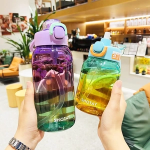 Macro view of gradient Tritan water bottles with straw and portable handles in hands