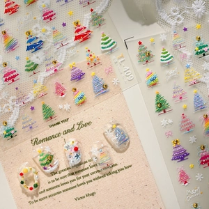 3D colorful Christmas tree nail stickers with snowflake patterns on festive background