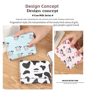 Detailed view of small faux leather tri-fold wallets featuring cow and strawberry patterns