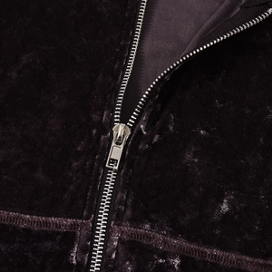 Detail of a smooth silver zipper on premium dark purple velvet hooded sweatshirt fabric
