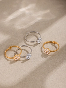 Detail of adjustable flower rings with water-drop cubic zirconia in gold and silver finish