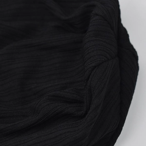 Detail of black ribbed knit fabric showing the premium vertical stripe texture and elasticity