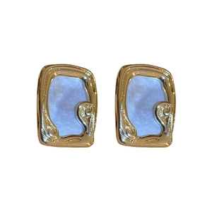 Retro gold-plated flower earrings with light blue marble inlay on white background