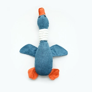 Detail of blue and orange plush duck toy made with durable denim-like fabric texture